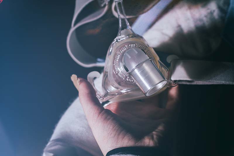 cpap-mask-held-by-hand-for-sleep-apnea-2026-03-09-23-14-16-utc