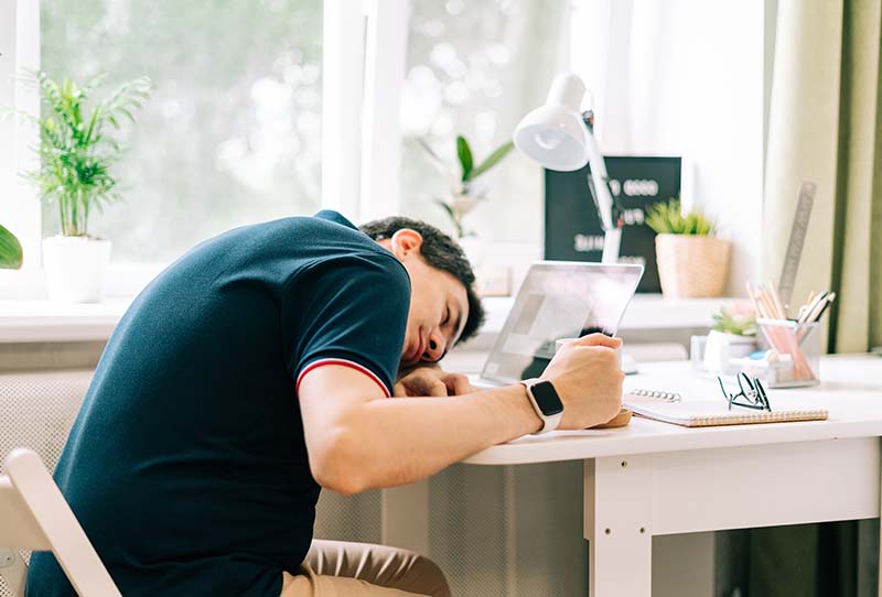 tired-man-resting-head-on-desk-at-home-2026-03-17-00-16-05-utc